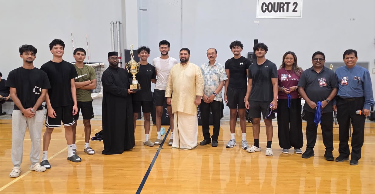 A team gathers with guests for a trophy presentation