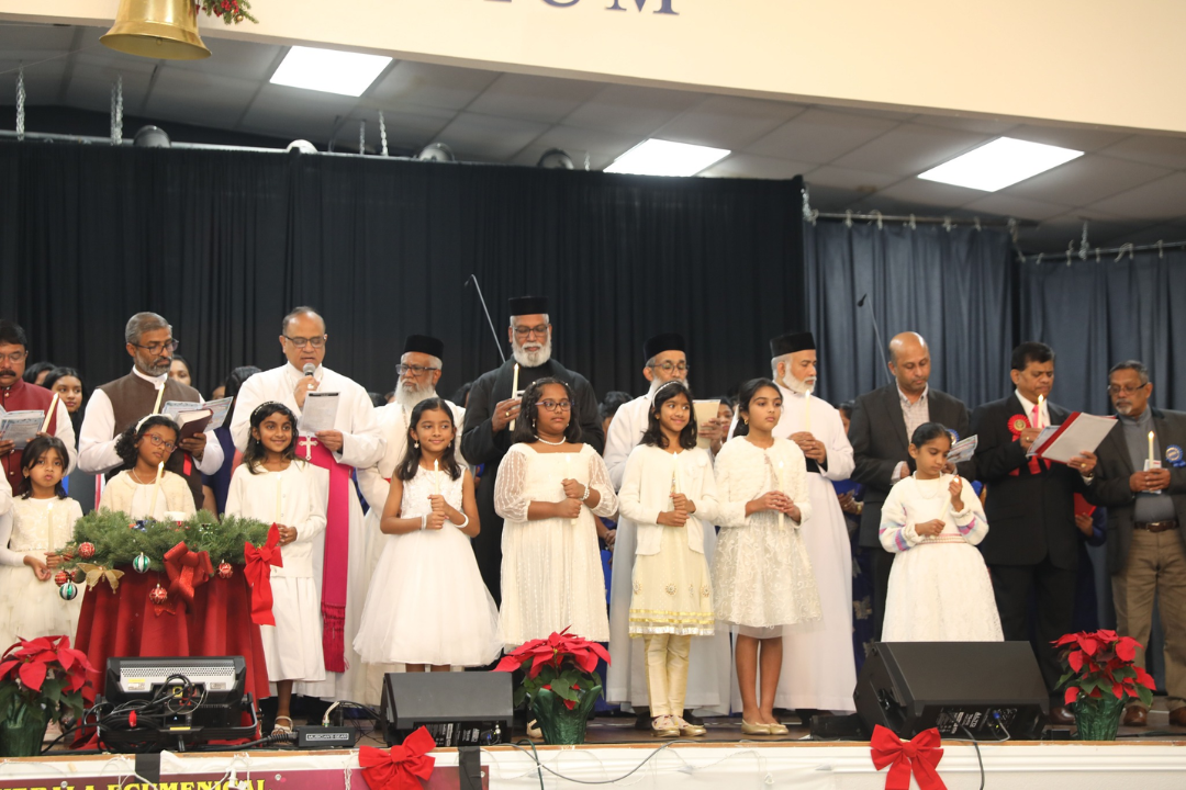 KECF clergy and children sharing a candlelight service